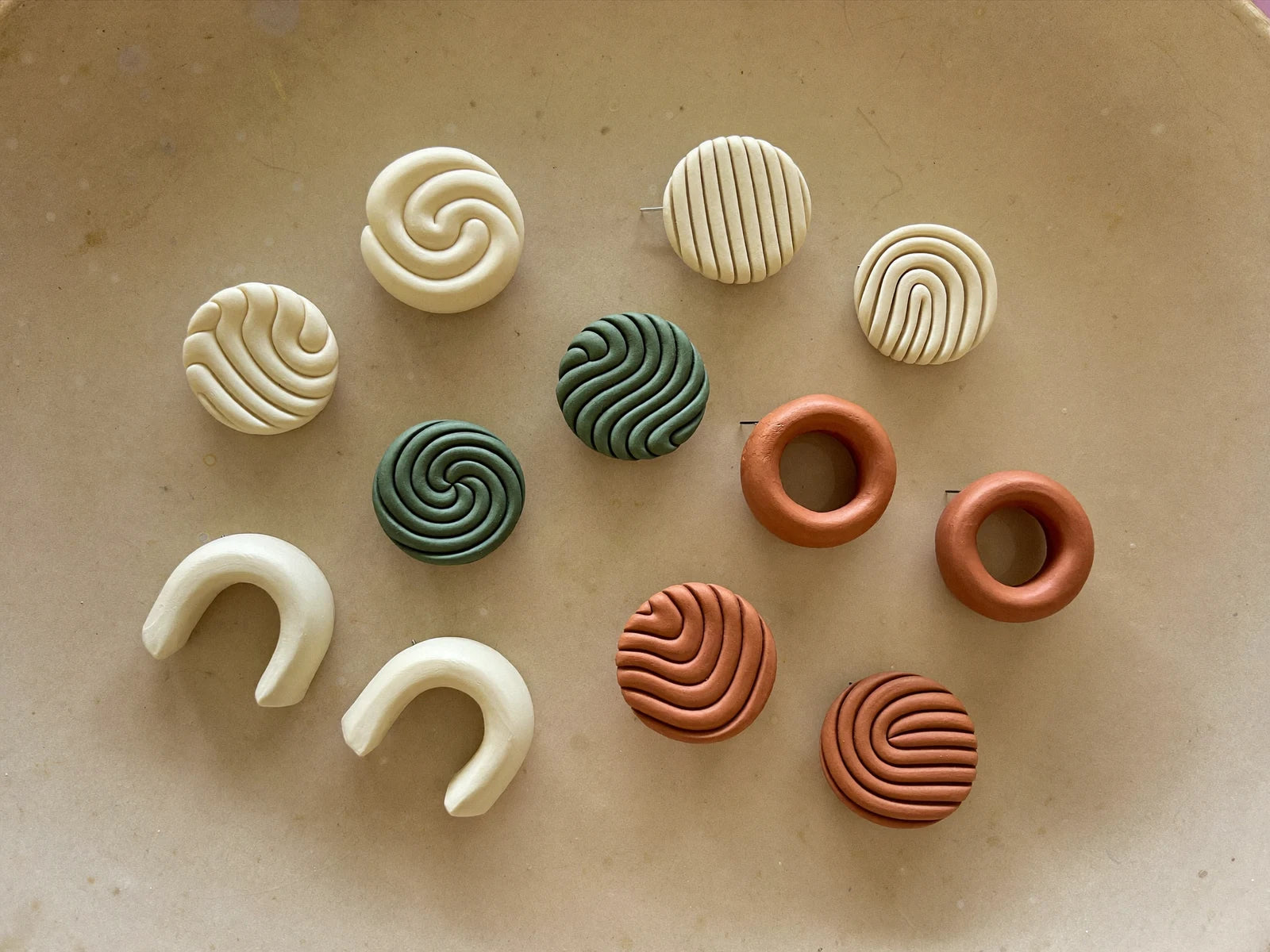 Geometric polymer clay stud earrings in boho tones.